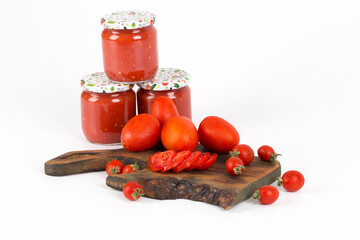 tomato sauces in handmade jar on wooden background and white background