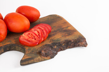 organic red tomatoes on wooden background on white background