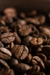 Coffee beans close-up. Macro photography of coffee on a brown background. A place for text in food photos. Arabica.