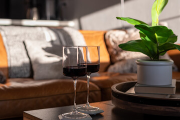 Two glasses of wine on a coffee table at home in natural sunlight