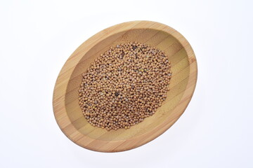 Seeds of sinapis alba in a wooden bowl on a white background, food. Spices.