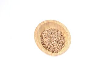 Seeds of sinapis alba in a wooden bowl on a white background, food. Spices.