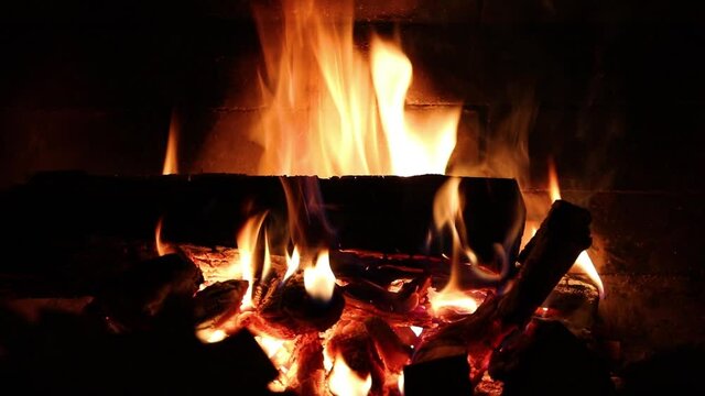 Fireplace background. Firewood. Flame in fireplace