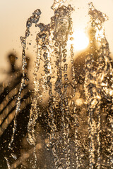 Background, an abstraction of water jets and drops of a fountain in the sun