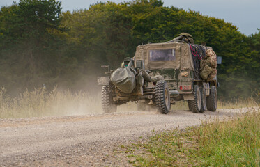 British army Steyr-Daimler-Puch BAE Systems Pinzgauer high-mobility 6x6 all-terrain vehicle tows a 105mm L118 Light Gun on military exercise Wilts UK © Martin