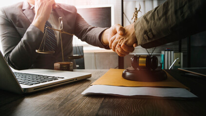 Business and lawyers discussing contract papers with brass scale on desk in office. Law, legal services, advice, justice and law concept picture with film grain effect