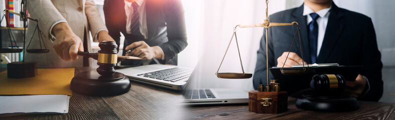 Business and lawyers discussing contract papers with brass scale on desk in office. Law, legal services, advice, justice and law concept picture with film grain effect