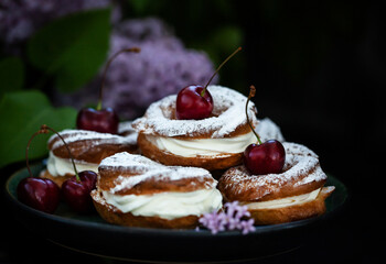 Cream puff rings (choux pastry) decorated with fresh cherry