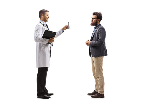 Young Male Doctor Showing Results On A Mobile Phone To A Patient