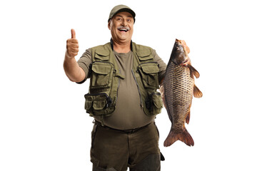 Happy fisherman holding a big carp fish and gesturing a thumb up sign