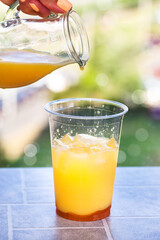 Making Bumble coffee - refreshment summer iced cocktail with espresso, orange juice, caramel syrup and ice