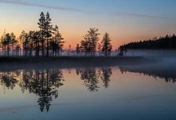 Fog over the lake. Fog over the forest. Fog over the swamp. Sunset. Dawn. Northern nature. Summer and autumn nature. Beautiful landscape.