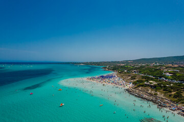 Aerial panoramic view of La Pelosa beach in Stintino, Sardinia with crystal clear turquoise water