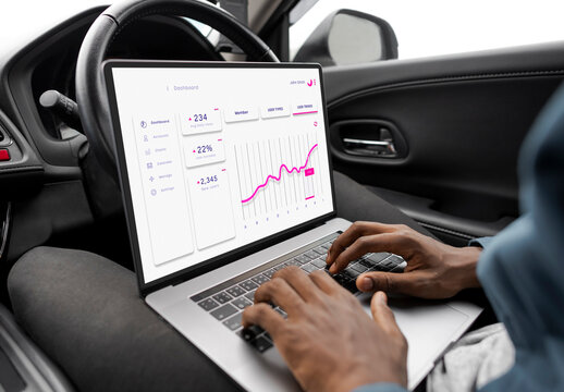 Mockup of Businessman Using Notebook Computer in a Car