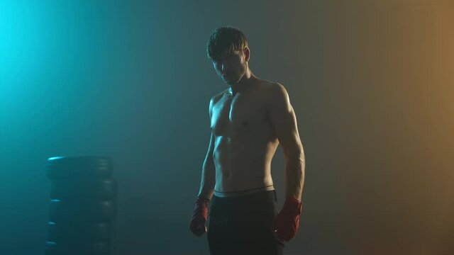 Image Of Strong Boxer In Dark Ring. Young Man Standing With Naked Torso.