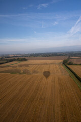 Obraz premium Aerial images of Wiltshire England taken from a hot air balloon. A cold and foggy morning flying over the recently harvested fields. 