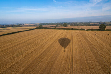 Obraz premium Aerial images of Wiltshire England taken from a hot air balloon. A cold and foggy morning flying over the recently harvested fields. 