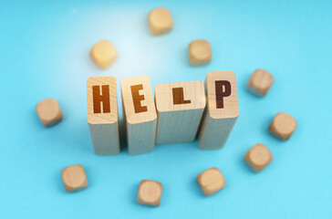 On a blue background, wooden cubes and Jenga with the inscription - help