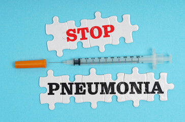 On a blue background, a syringe and puzzles with the inscription - STOP PNEUMONIA