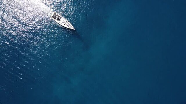 Parasailing, Parasailing Behind a Boat. Man flies over the sea on a parachute tied a rope to the boat on the background of the mountains
