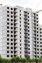 Construction of buildings. Multi-storey residential construction. Concrete frame of the house. Residential complex in nature