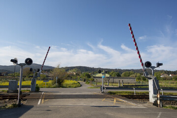 Level crossing with a barrier on a railroad track in Valga, Galicia, Spain