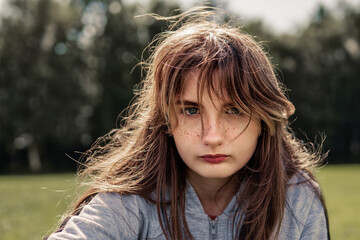 Casual portrait of teenager girl in a park, Selective focus. The model is with light make up and...