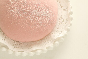 cherry blossom pink bun on dish for spring sweet food image
