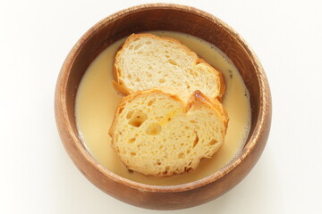 sliced French bread in egg wash for French toast cooking image