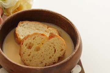 sliced French bread in egg wash for French toast cooking image