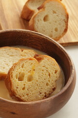 sliced French bread in egg wash for French toast cooking image