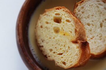 sliced French bread in egg wash for French toast cooking image
