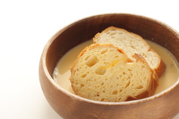 sliced French bread in egg wash for French toast cooking image