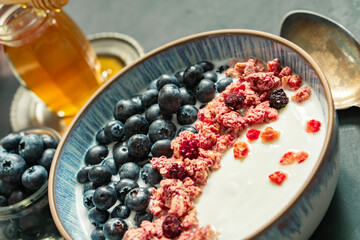 Berry mix bowl supper food with healthy granola grain muesli in yogurt for breakfast food meal with honey blueberry strawberry 