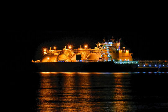 LNG tanker moored in the factory area at night.
