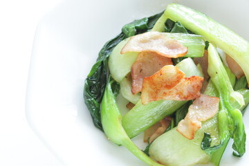 Chinese food, green leaves vegetable Pak chow stir fried with bacon