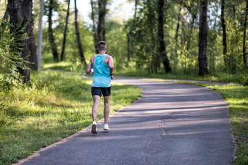 A running sportsman in a park on summer morning.