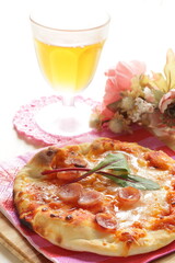 homemade sausage and cheese pizza on red paper napkin