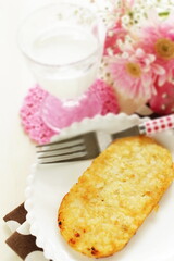 American breakfast, hashed brown on white dish with fork
