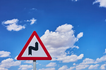 traffic sign indicating a zig zag on the highway