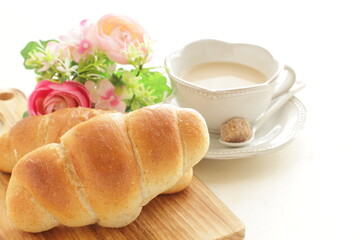 Homemade salt on butter roll bun on wooden bread board for breakfast 