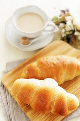 Homemade salt on butter roll bun on wooden bread board for breakfast 