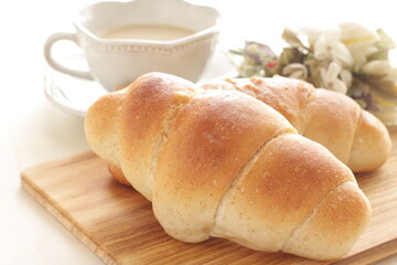 Homemade salt on butter roll bun on wooden bread board for breakfast 