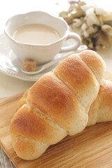 Homemade salt on butter roll bun on wooden bread board for breakfast 