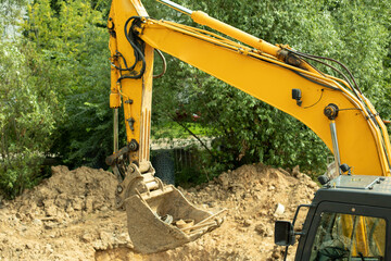 Construction machinery is digging a hole.