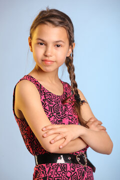 Portrait With Bare Arms Bright Cheerful Cute Dark-haired Teenage Girl 12 Years Old In A Purple Dress.