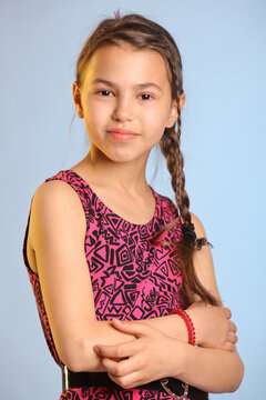 Portrait With Bare Arms Bright Cheerful Cute Dark-haired Teenage Girl 12 Years Old In A Purple Dress.