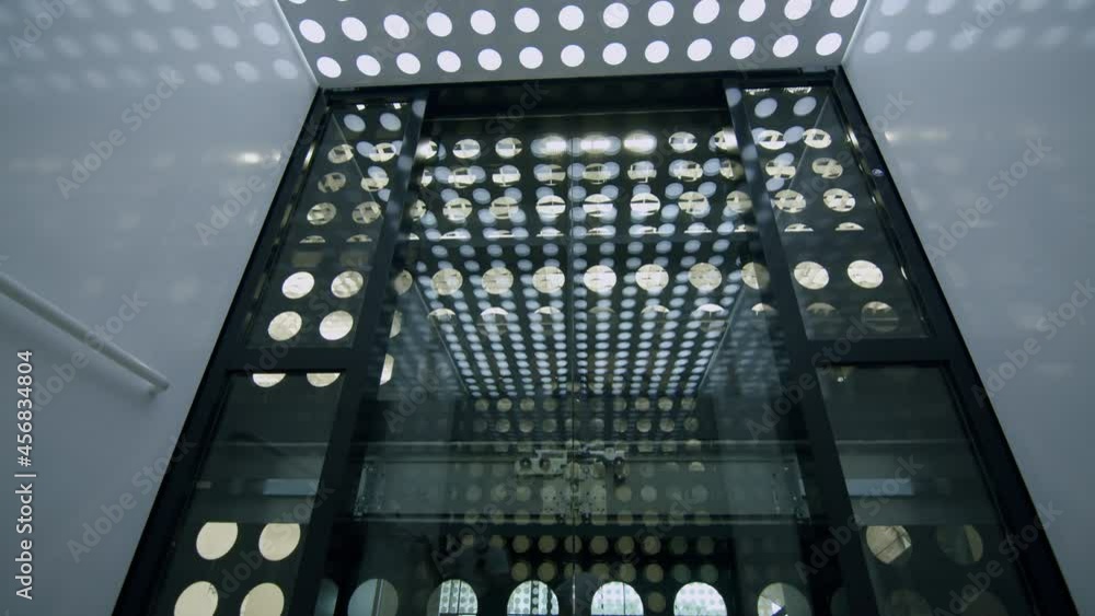 Aufkleber slowmotion low angle shot of inside elevator with circles pattern going dwon