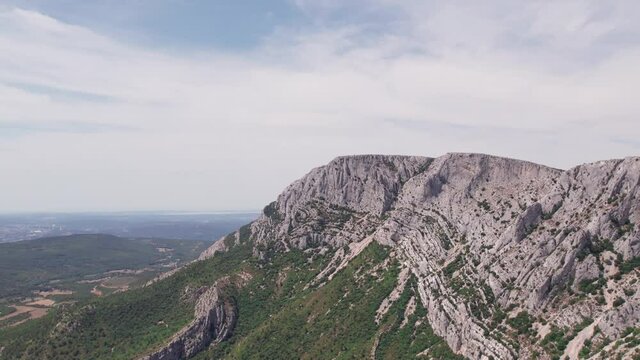 Aerial video of a drone ascending revealing the majestic Sainte-Victoire mountain range in France.