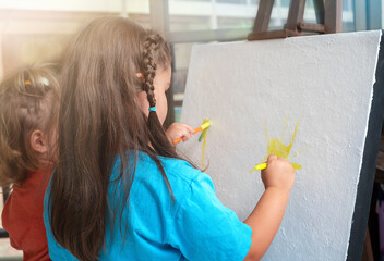 Children paint on canvas  together